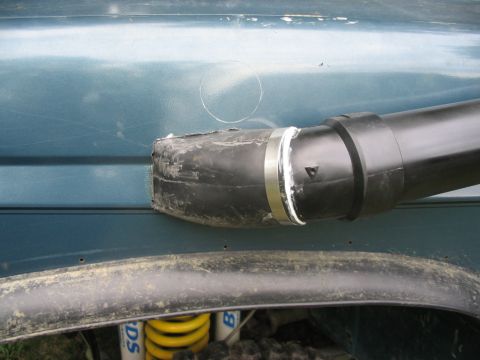 1986 Ford Bronco - Snorkel installed on the fender of a vehicle, showing part of the suspension below.