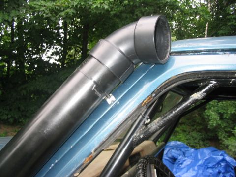 1986 Ford Bronco - A black snorkel is mounted to the A-pillar and roof of a light blue vehicle.
