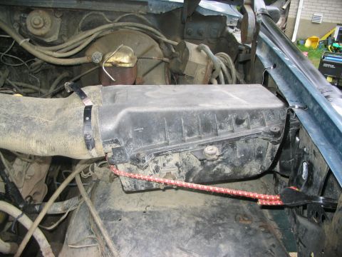 1986 Ford Bronco - The engine bay of a vehicle, showing the air intake system and brake fluid reservoir.
