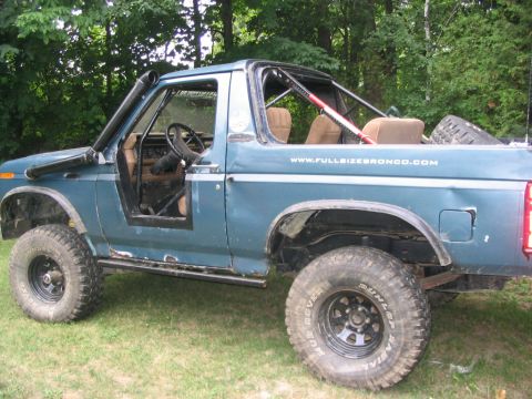 1986 Ford Bronco - This modified SUV features a snorkel intake and a roll cage, indicating it's built for off-road use.