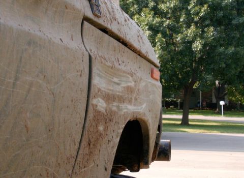 1978 Ford Bronco - This vehicle's side is heavily covered in mud, obscuring most details and making year identification impossible.