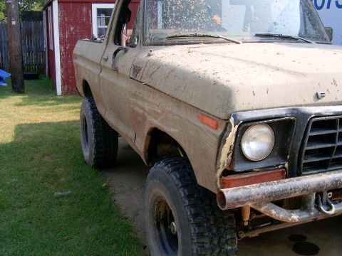 1978 Ford Bronco - This 1978 Ford Bronco is covered in mud, showing its front quarter with an aftermarket bumper.