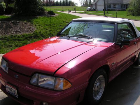 1990 Ford Mustang - This 1990 Ford Mustang convertible features a '5.0' badge on its fender, confirming its model year and trim.
