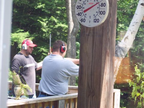 2001 Ford Crown Victoria - A thermometer reads 70 degrees Fahrenheit as two men, wearing ear protection, engage in target practice outdoors.