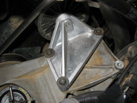 1995 Ford Bronco - Close-up of an engine bracket with visible text and hardware.