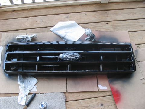 1988 Ford Bronco - A black 1988 Ford Bronco grille, the Ford emblem, is shown after being painted.