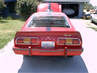 1978 Ford Mustang II - Rear view of a red 1978 Ford Mustang II with louvred windows and racing stripes.