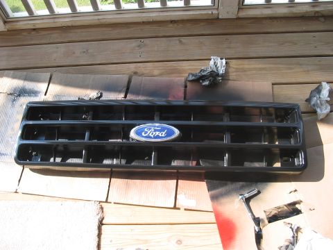 1988 Ford Bronco - Painting a Ford Bronco grille, likely from a 1988 model, on a wooden deck.