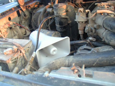 1988 Ford Bronco - The engine bay of a vehicle contains a white speaker and the Supermotors.net logo is visible.