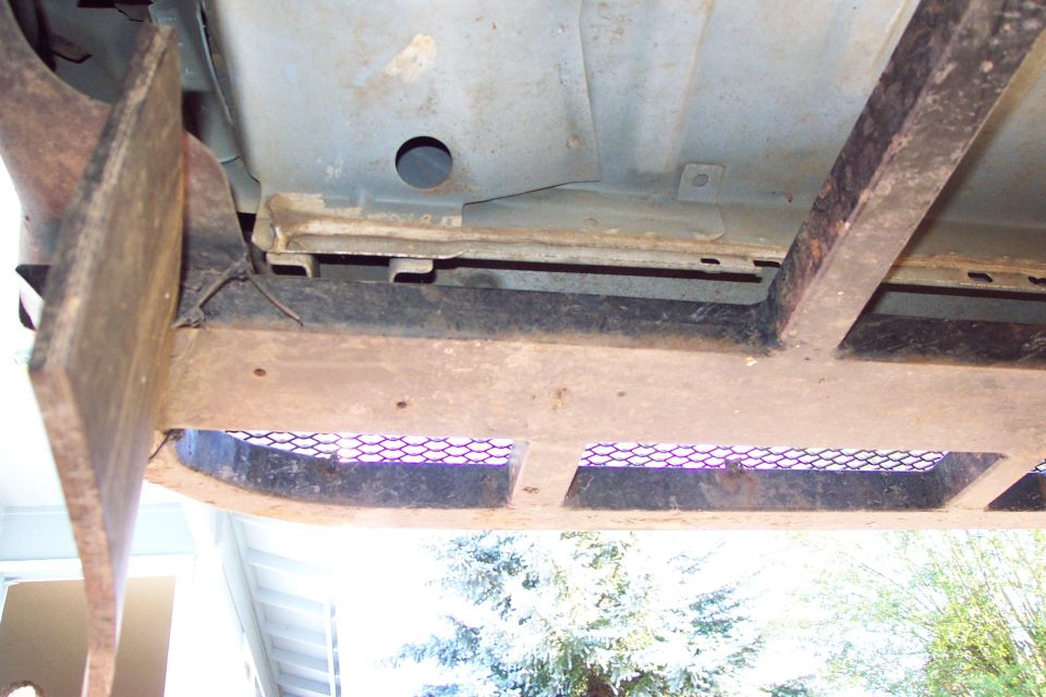 Upward/Lift Force is Transferred to Front Body Support Structure

Also seen are two drain holes for the cut-out to clear the front fender mount that hangs down.