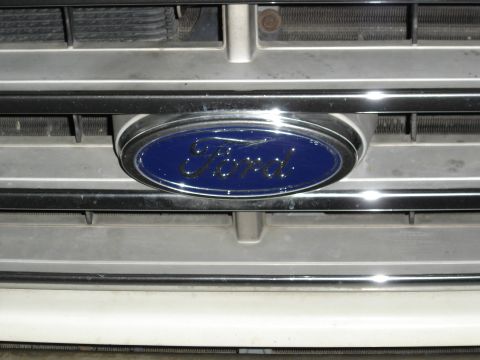 1988 Ford Bronco - Close-up of the Ford emblem on the grille of a 1988 Ford Bronco.