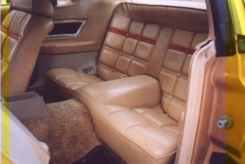 1978 Ford Mustang II - The quilted tan interior of a 1978 Ford Mustang II, viewed from the rear passenger side.
