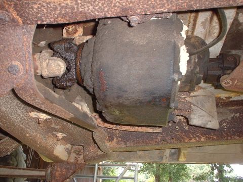 1976 Ford F-150 - Close-up view of the heavily corroded drivetrain components of an unidentified truck.