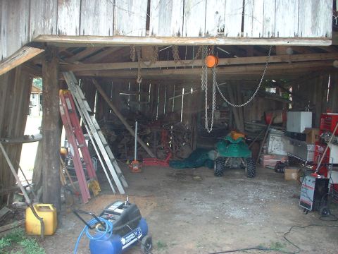 1976 Ford F-150 - Barn interior filled with various items including an ATV, air compressor, and ladders.