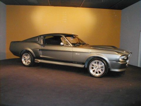 1994 Ford Bronco - A classic gray Shelby GT500 is displayed indoors with a yellow wall in the background.