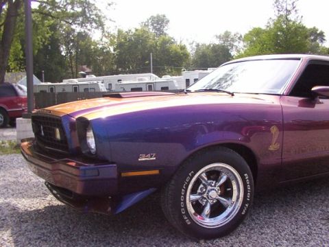 1978 Ford Mustang II - This 1978 Ford Mustang II features a distinctive purple and orange paint scheme, a cobra emblem, and a 347 badge.
