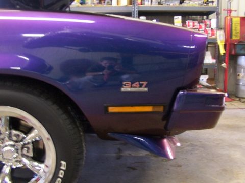 1978 Ford Mustang II - Close-up of a purple car's rear fender and wheel, showing a '347' badge.