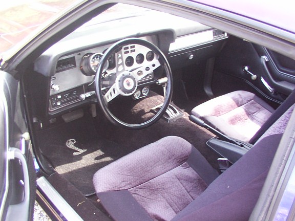 Interior of a 1978 Ford Mustang II Cobra II with a Cobra snake floor mat