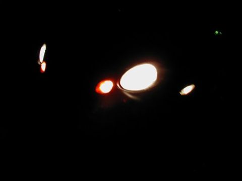 1997 Ford Taurus - Vehicle lights are illuminated in the darkness, showing headlights and taillights.