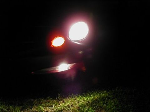 1997 Ford Taurus - Front view of a 1997 Ford Taurus headlight and turn signal glowing in the dark.
