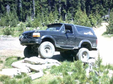 1995 Ford Bronco - This 1995 Ford Bronco navigates a rocky obstacle on an off-road trail.