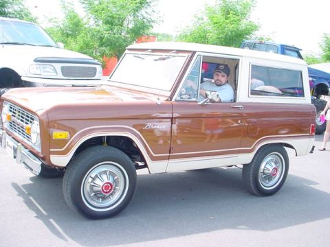 1979 Ford Bronco - A brown 1979 Ford Bronco is parked outdoors with a driver inside.