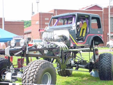 1979 Ford Bronco - This heavily modified vehicle features a prominent engine and oversized tires, suggesting it's built for off-road performance.