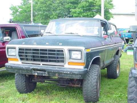 1979 Ford Bronco - Dark Ford Bronco parked outdoors with other vehicles nearby.