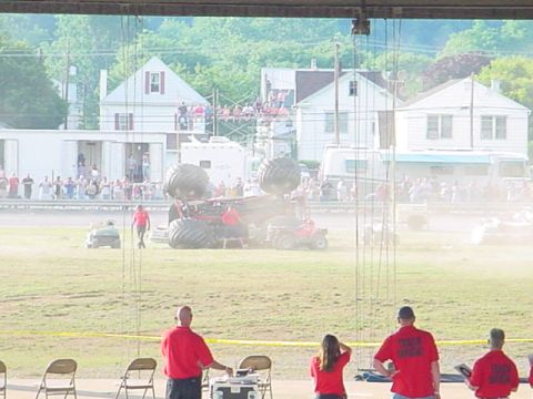1979 Ford Bronco - Monster truck event with a large crowd and multiple vehicles visible.