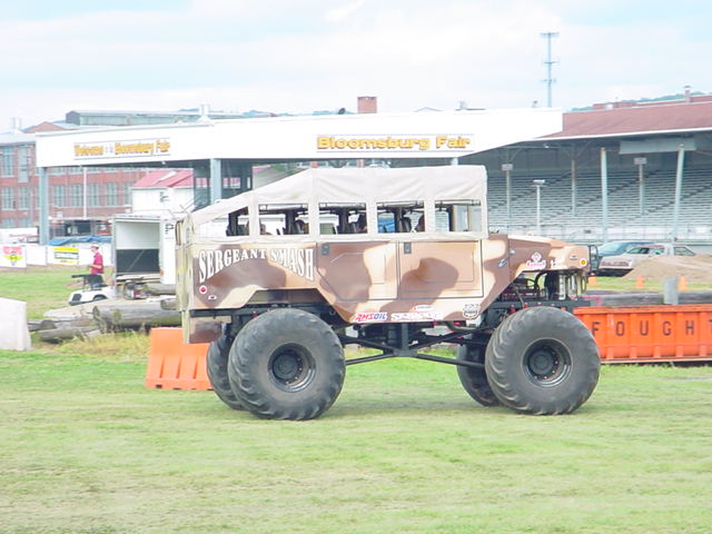 Monster truck with camouflage paint and 'SERGEANT SMASH' text, side view