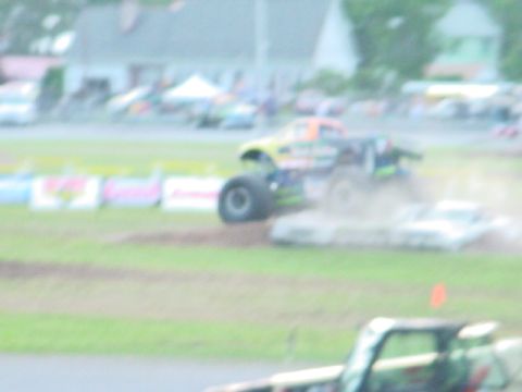 1979 Ford Bronco - Monster truck event with multiple vehicles and spectators in the background.