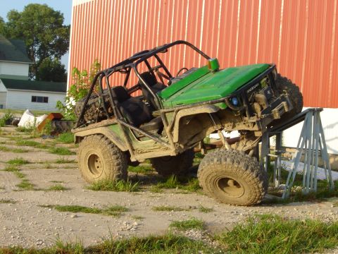 1992 Ford Bronco - Modified buggy with roll cage is elevated on stands in a rural setting.