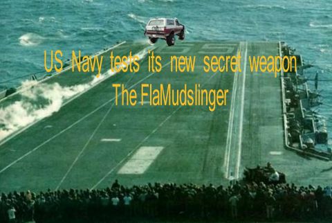 1993 Ford Bronco - SUV airborne over an aircraft carrier deck with text overlay 'US Navy tests its new secret weapon The FlaMudslinger'.