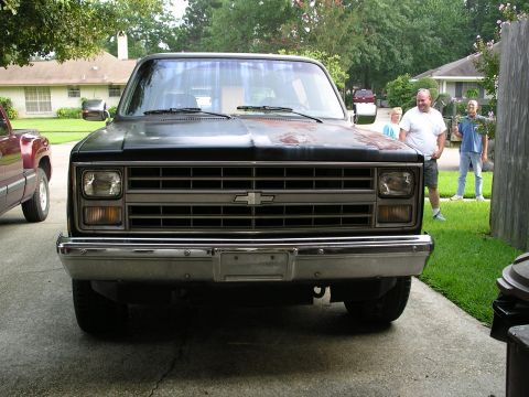 1984 Chevrolet Blazer - Front view of a 1984 Chevrolet Blazer parked in a driveway with another truck nearby.