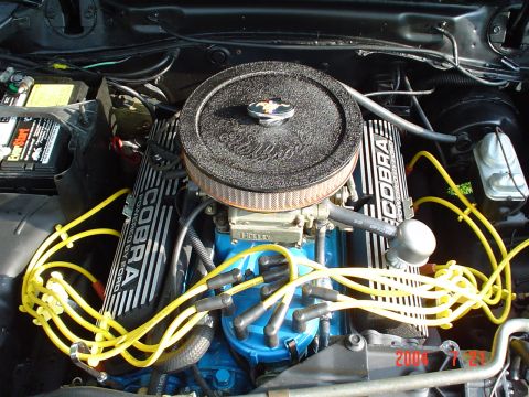 1978 Ford Mustang II - Close-up of an engine bay Cobra valve covers and yellow spark plug wires.