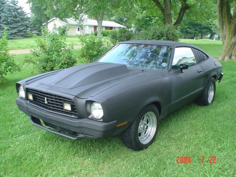 1978 Ford Mustang II - 1978 Ford Mustang II coupe with a custom hood scoop and wheels sits on a grassy lawn.