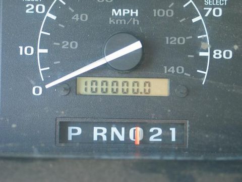 1995 Ford Bronco - Close-up of vehicle dashboard gauges, including the speedometer and odometer reading 100,000 miles.
