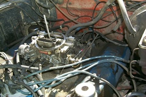 1978 Ford Bronco - Close-up of an engine bay, focusing on the carburetor and associated wiring.
