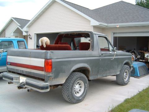 1987 Ford Bronco - This 1987 Ford Bronco is missing its top and has a stuffed animal in the passenger seat.