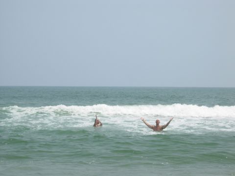 1995 Ford Bronco - Two people enjoy the ocean waves at Ocracoke Island, NC.