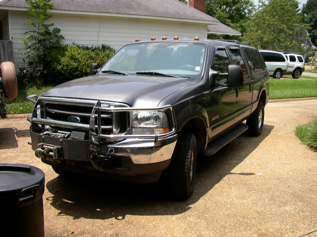 Gray SUV with brush guard and winch, 3q-front view. Seen in 2003