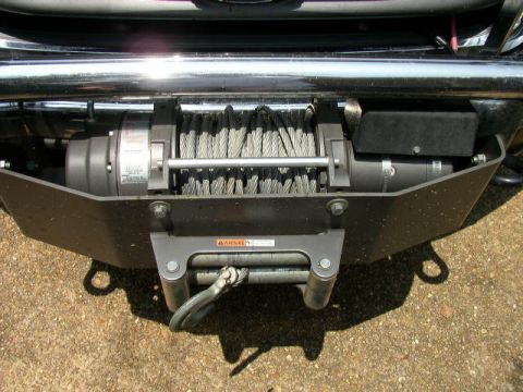 1995 Ford Bronco - Close-up of a vehicle's front bumper and winch assembly.