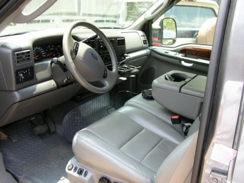 1995 Ford Bronco - Interior view of a gray truck, showing the dashboard, steering wheel, and seats.