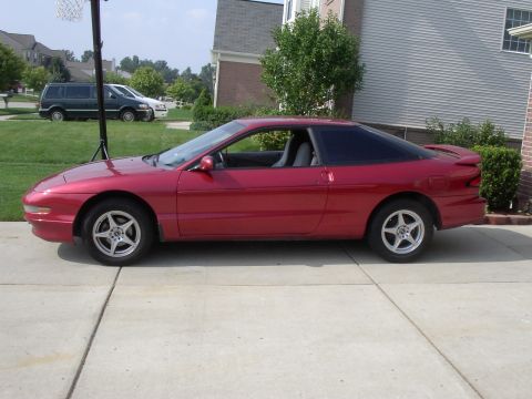 1996 Ford Probe - A red 1996 Ford Probe is parked in a driveway on a sunny day.