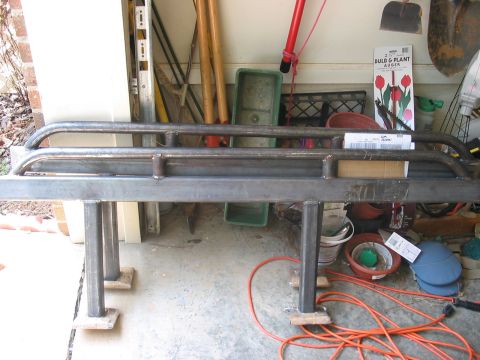 1988 Ford Bronco - Custom metal bumper or brush guard, possibly for an off-road vehicle, is shown in a garage setting.