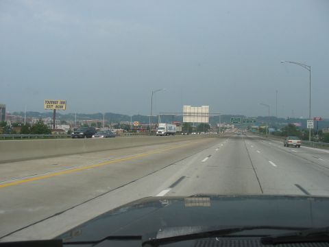1988 Ford Bronco - Driving on a multi-lane highway with traffic under an overcast sky.