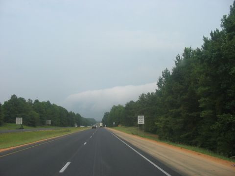1988 Ford Bronco - A highway scene with trees and a cloudy sky, showing multiple vehicles in the distance.