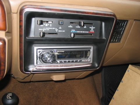 1988 Ford Bronco - The interior dashboard features climate controls and an aftermarket Kenwood stereo system.