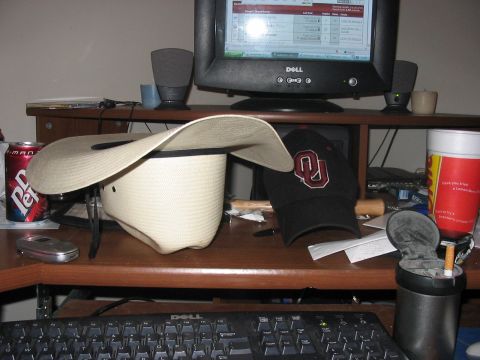 1988 Ford Bronco - A cluttered desk features a cowboy hat, a baseball cap, a Dr. Pepper can, and a computer monitor.