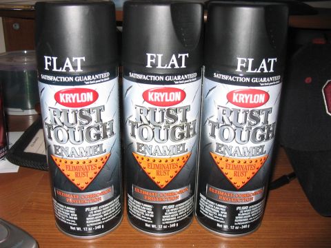 1988 Ford Bronco - Three cans of flat black spray paint are lined up, ready for use.